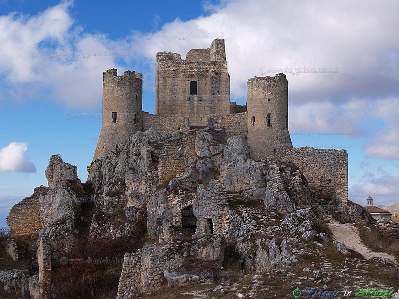 01-PB254215+.jpg - 01-PB254215+.jpg - La fortezza di Rocca Calascio (XIII sec.), nel Parco Nazionale del Gran Sasso-Monti della Laga. Il suggestivo castello, posto su una cresta rocciosa a dominio della Piana di Navelli e della vallata del Tirino, è, con i suoi 1.512 m. di altitudine, uno dei fortilizi più elevati d'Europa. Nelle vicinanze della rocca si trova l'antica chiesa di S. Maria della Pietà (XVI sec.). Il castello di Rocca Calascio è stato il set naturale di diversi films di successo, tra cui "Lady Hawke", "Il nome della rosa" e "Padre Pio". 